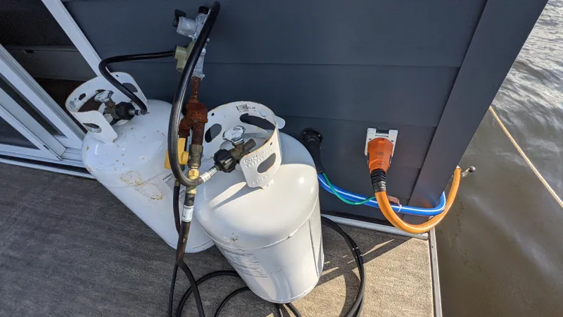 Slide: The Image of Propane tanks and electrical connections on 2022 Houseboat 36' A&M Manufacturing. - 20