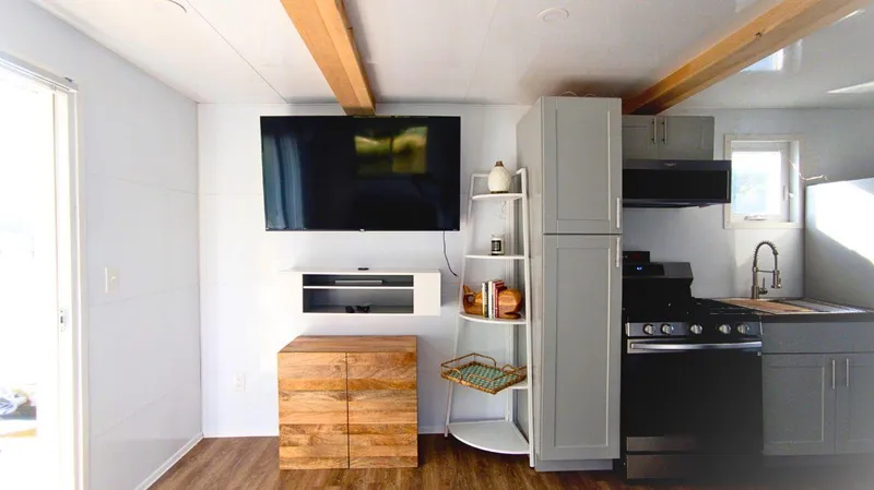Slide: The Image of Modern 2022 houseboat interior with TV, kitchen, and wooden accents. - 5