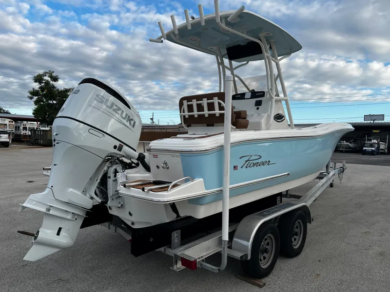 Slide: The Image of 2024 Pioneer 222 Sportfish boat with Suzuki outboard motor on trailer. - 13