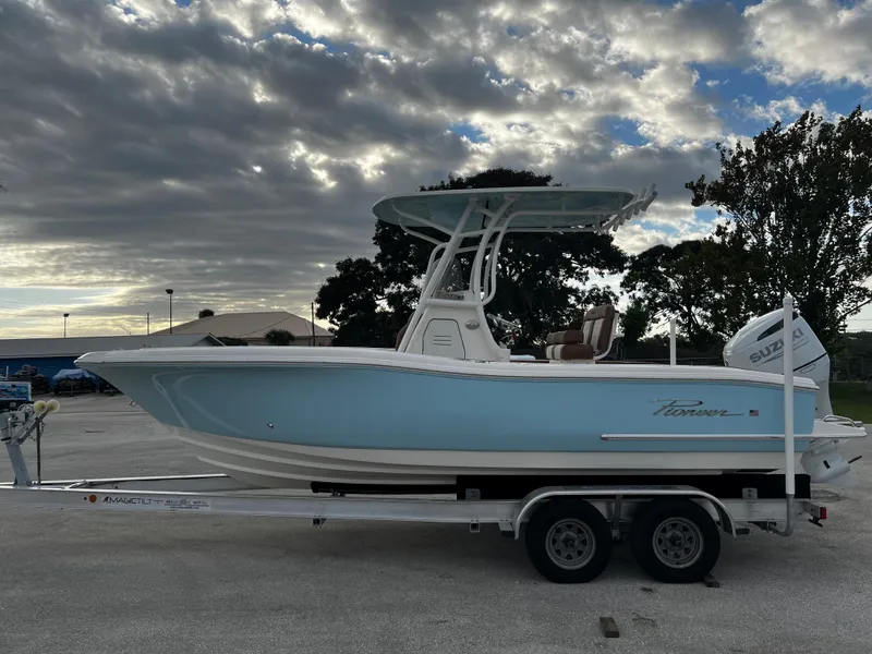 Slide: The Image of 2024 Pioneer 222 Sportfish boat on a trailer under a cloudy sky. - 16