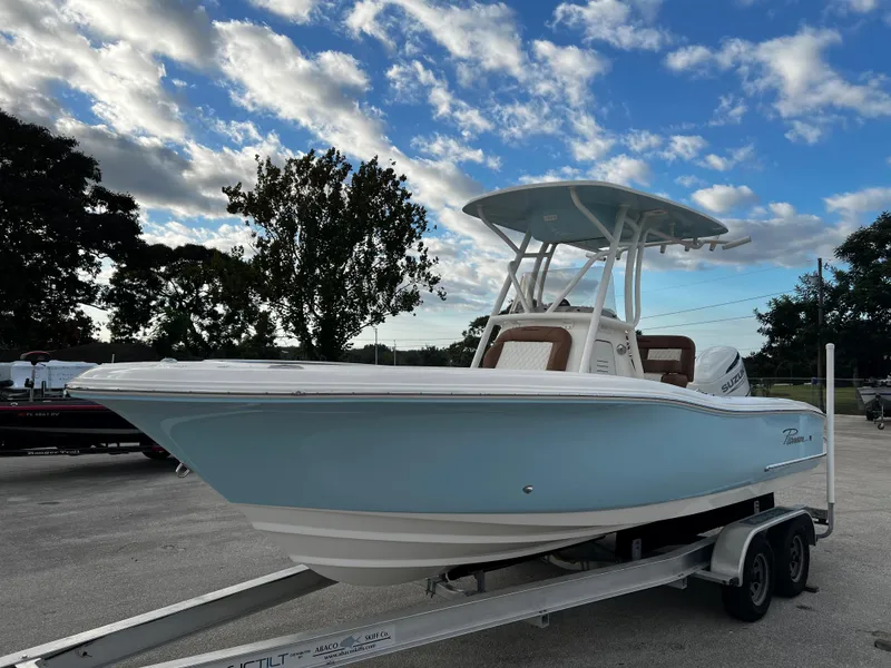 Slide: The Image of 2024 Pioneer 222 Sportfish boat on trailer under a partly cloudy sky. - 17