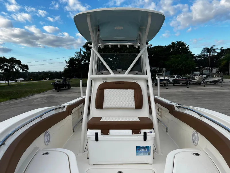 Slide: The Image of 2024 Pioneer 222 Sportfish boat with cushioned seating and T-top. - 19