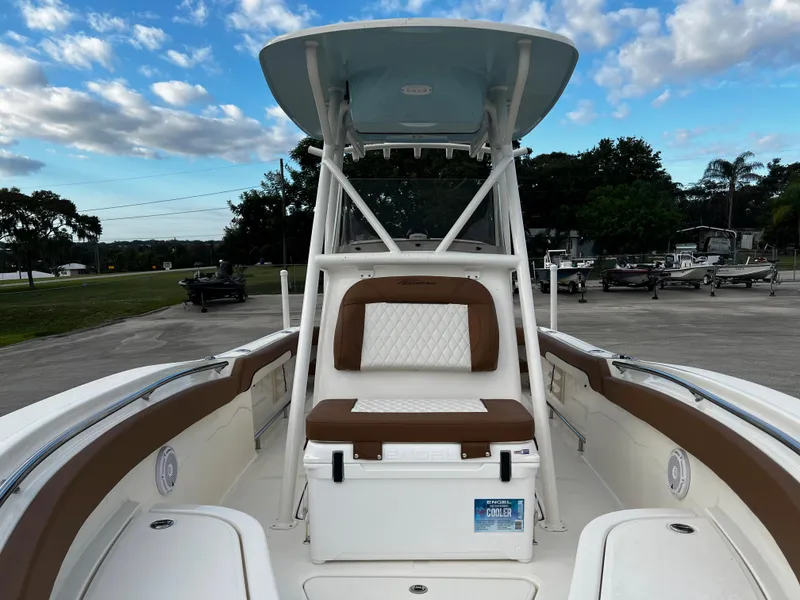 Slide: The Image of 2024 Pioneer 222 Sportfish boat with cushioned seating and T-top. - 20