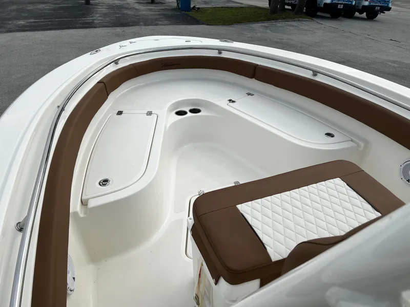 Slide: The Image of 2024 Pioneer 222 Sportfish boat interior with brown and white seating. - 27