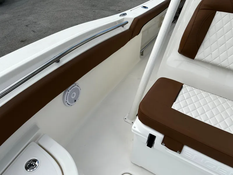 Slide: The Image of 2024 Pioneer 222 Sportfish boat interior with brown and white seating. - 28