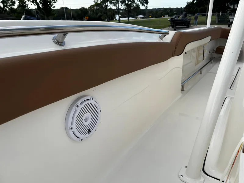 Slide: The Image of 2024 Pioneer 222 Sportfish boat interior with brown trim and built-in speaker. - 30