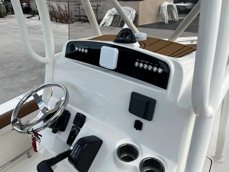 Slide: The Image of Control console of 2024 Pioneer 222 Sportfish boat with steering wheel and electronic controls. - 31