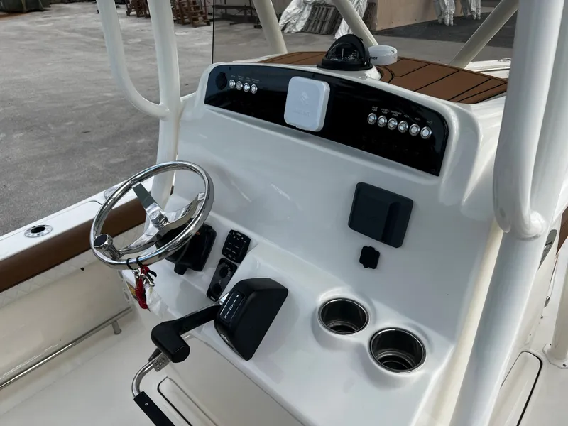 Slide: The Image of 2024 Pioneer 222 Sportfish boat console with steering wheel and controls. - 32