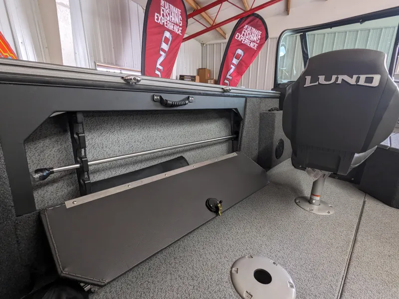 Slide: The Image of 2025 Lund 1875 Fisherman boat interior with storage compartment and branded seat. - 11