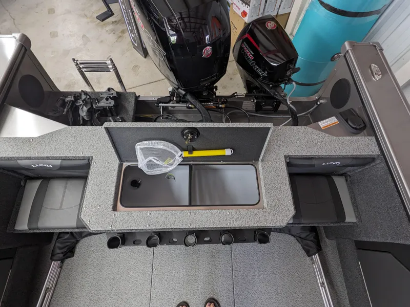 Slide: The Image of 2025 Lund 1875 Fisherman boat interior with fishing net and motor. - 7