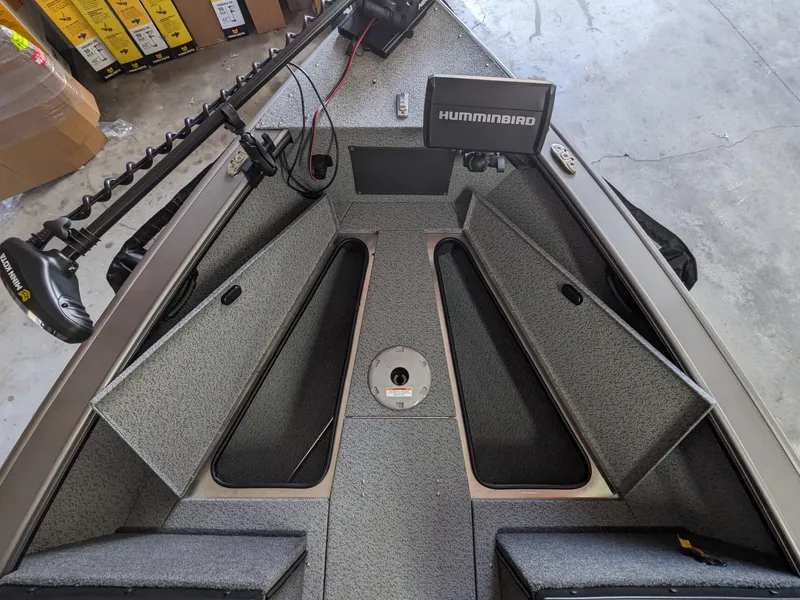 Slide: The Image of 2025 Lund 1875 Fisherman boat interior with Humminbird fish finder and storage compartments. - 9