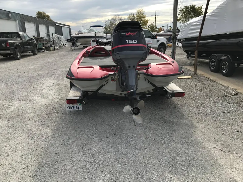 Slide: The Image of 2007 Stratos 285 XL boat with 150 HP motor in a gravel lot. - 12
