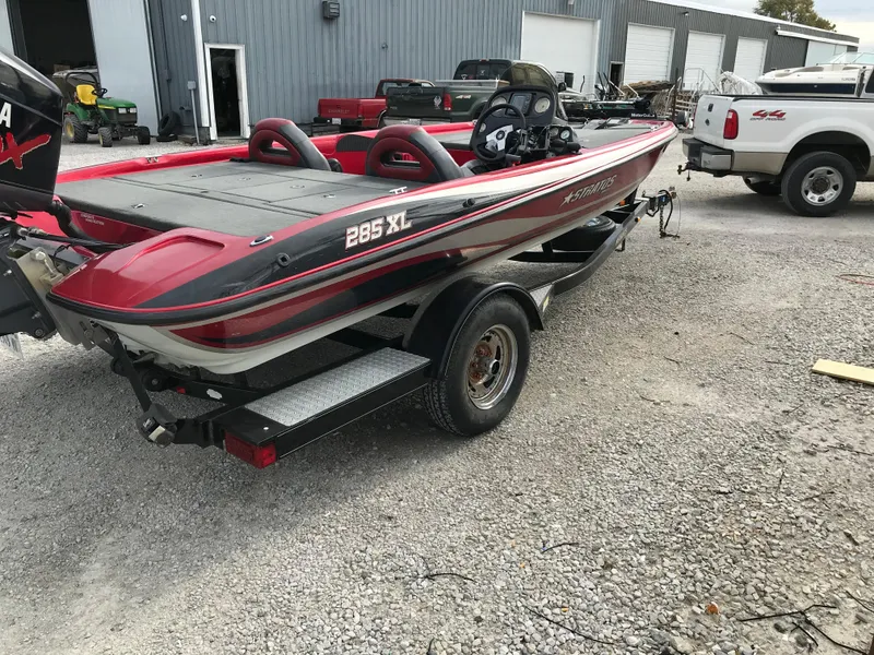 Slide: The Image of 2007 Stratos 285 XL boat on trailer in a yard. - 17