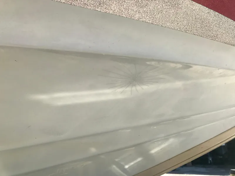 Slide: The Image of Close-up of a 2007 Stratos 285 XL boat hull with visible crack. - 19