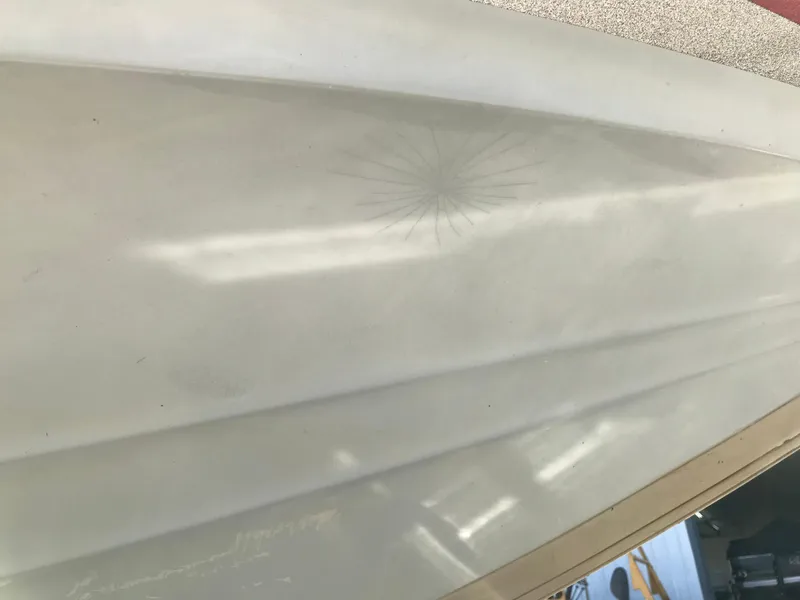 Slide: The Image of Close-up of a 2007 Stratos 285 XL boat hull with visible surface crack. - 22