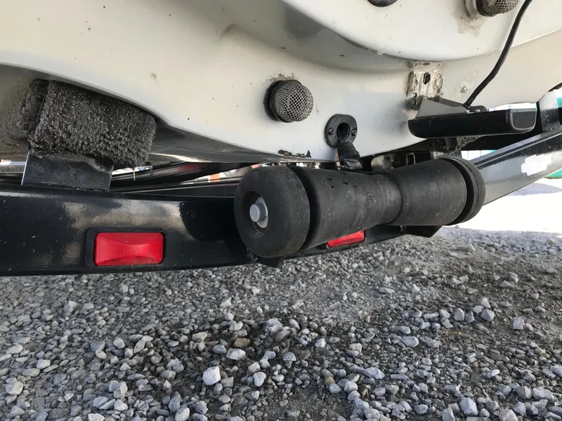 Slide: The Image of Close-up of 2007 Stratos 285 XL boat trailer roller on gravel surface. - 24