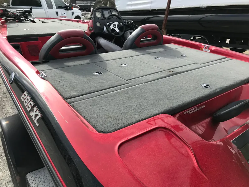 Slide: The Image of 2007 Stratos 285 XL bass boat with red exterior and spacious deck. - 5