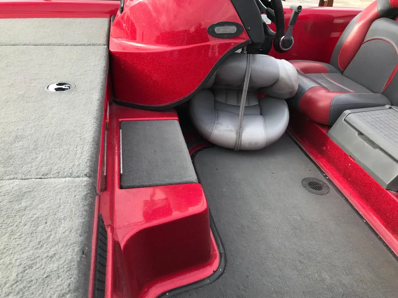 Slide: The Image of 2007 Stratos 285 XL boat interior with red and gray seating and carpeted deck. - 8