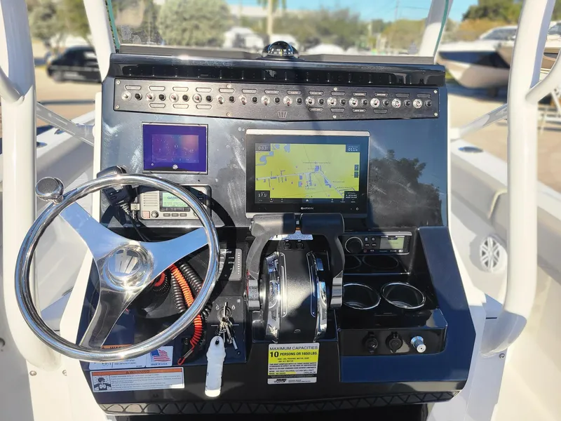 Slide: The Image of 2023 Wellcraft 242 Fisherman boat dashboard with steering wheel and navigation system. - 12