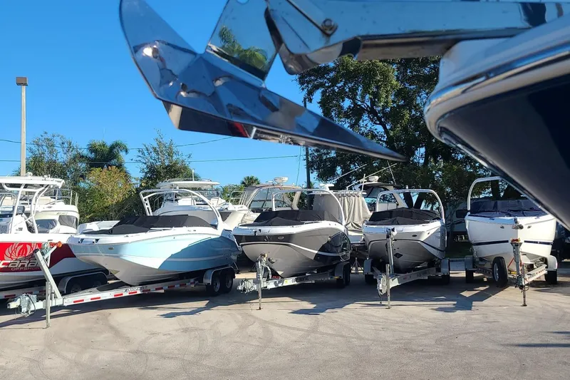 Slide: The Image of Several Wellcraft 242 Fisherman boats from 2023 on trailers in a dealership lot. - 22