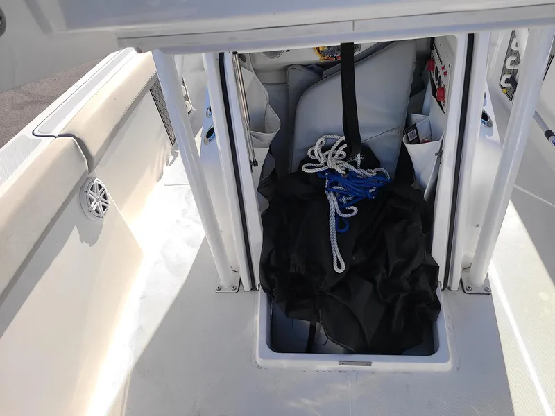 Slide: The Image of 2023 Wellcraft 242 Fisherman boat storage compartment with ropes and gear. - 8
