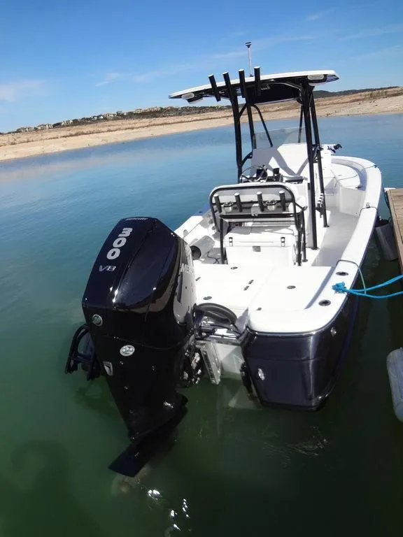 Slide: The Image of 2024 BlackJack 256 Bay boat with powerful outboard motor on calm water. - 15