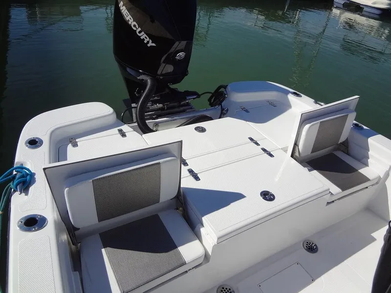 Slide: The Image of 2024 BlackJack 256 Bay boat with Mercury engine, featuring foldable seats and spacious deck. - 22