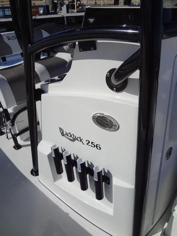 Slide: The Image of 2024 BlackJack 256 Bay boat interior with rod holders and seating. - 23