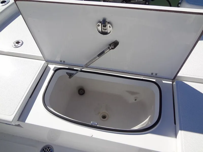 Slide: The Image of 2024 BlackJack 256 Bay boat storage compartment with open lid. - 24