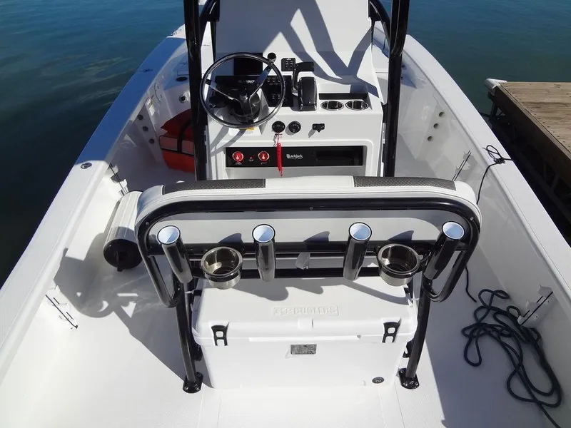 Slide: The Image of 2024 BlackJack 256 Bay boat interior with steering console and rod holders. - 27