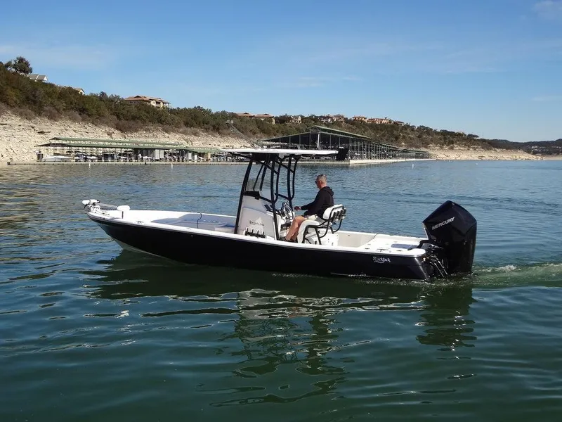 Slide: The Image of 2024 BlackJack 256 Bay boat cruising on a calm lake. - 9