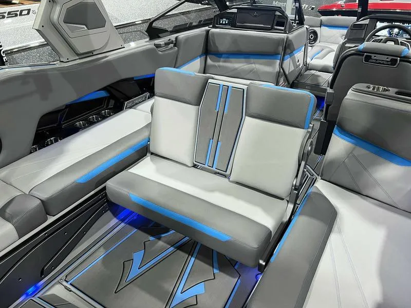 Slide: The Image of 2024 Supra SL boat interior with modern gray and blue seating design. - 11