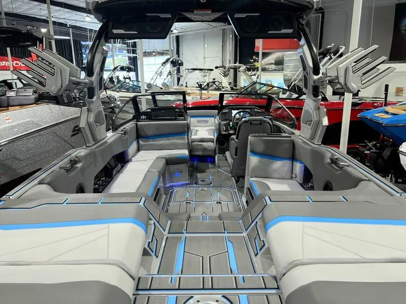 Slide: The Image of 2024 Supra SL boat interior with modern seating and sleek design in showroom. - 20
