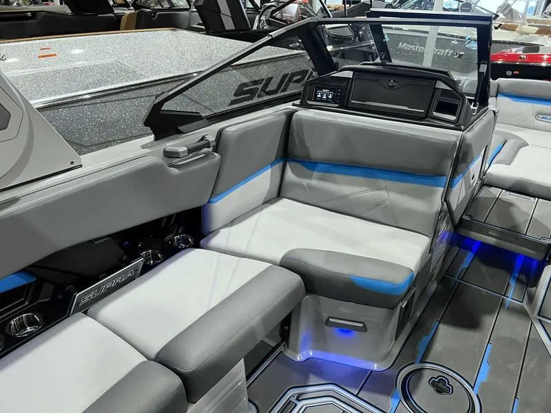 Slide: The Image of 2024 Supra SL boat interior with modern seating and blue LED lighting. - 28