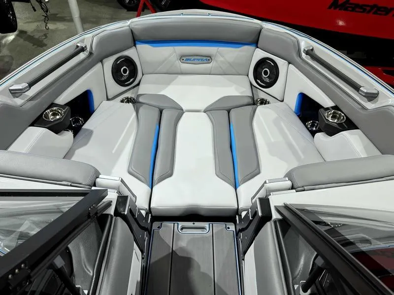 Slide: The Image of 2024 Supra SL boat interior with gray and blue seating, premium speakers, and cup holders. - 31