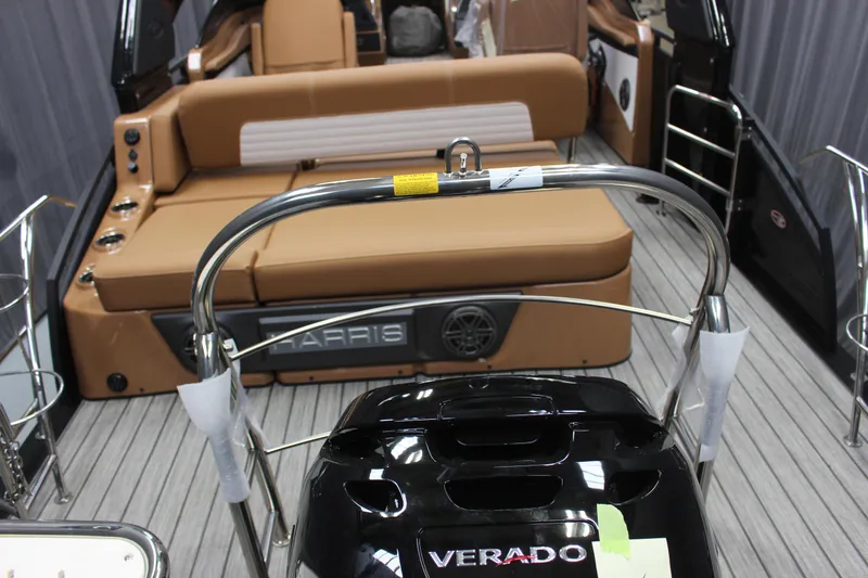 Slide: The Image of 2023 Harris Solstice DC 250 boat interior with Verado engine and tan seating. - 5