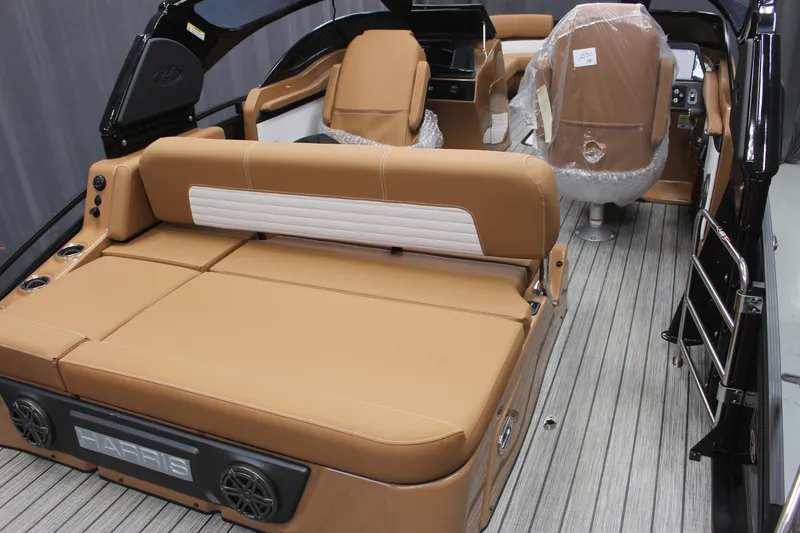 Slide: The Image of 2023 Harris Solstice DC 250 boat interior with tan leather seating and modern design. - 6