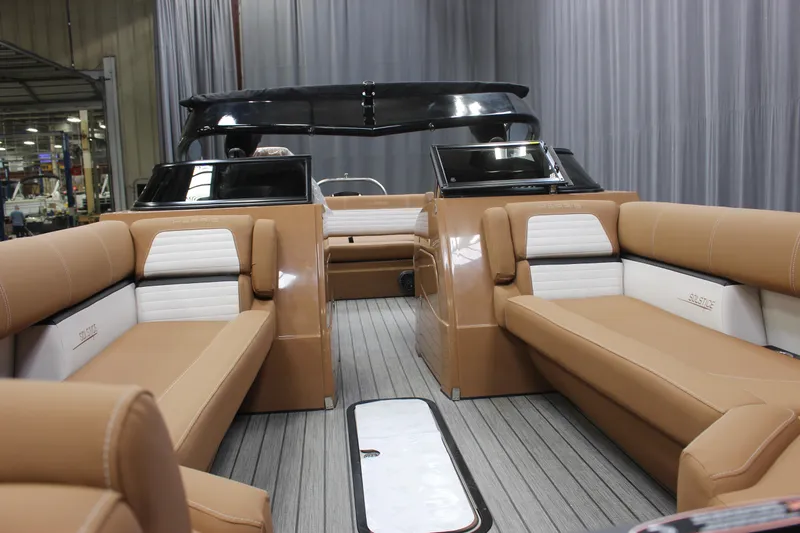Slide: The Image of 2023 Harris Solstice DC 250 boat interior with tan and white seating. - 8