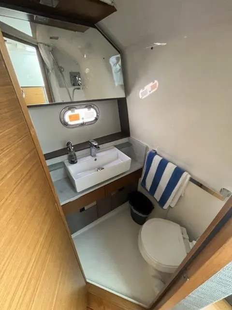 Slide: The Image of 2021 Tiara Yachts 38 LS bathroom with sink, toilet, and window. - 12