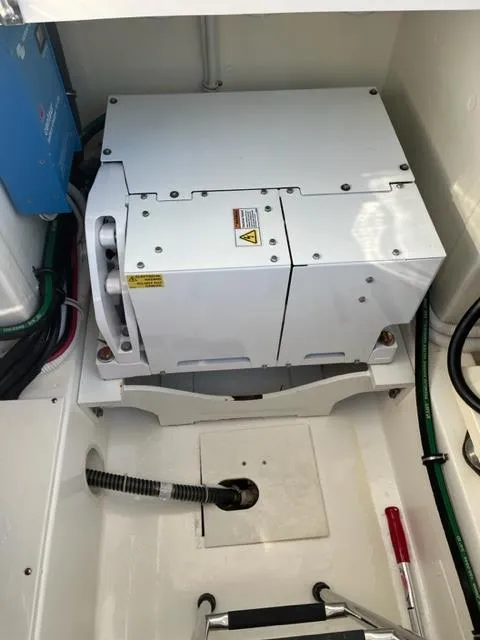 Slide: The Image of Engine compartment of a 2021 Tiara Yachts 38 LS, showcasing machinery and wiring. - 13