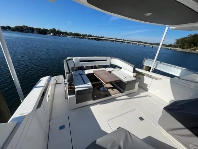 Slide: The Image of 2021 Tiara Yachts 38 LS with spacious deck and seating area on a serene lake. - 3