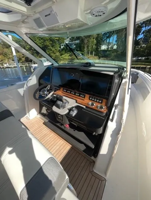 Slide: The Image of 2021 Tiara Yachts 38 LS helm station with modern controls and navigation systems. - 5