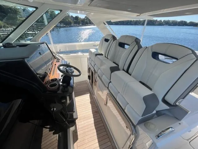 Slide: The Image of 2021 Tiara Yachts 38 LS interior with helm and seating, overlooking serene waters. - 6