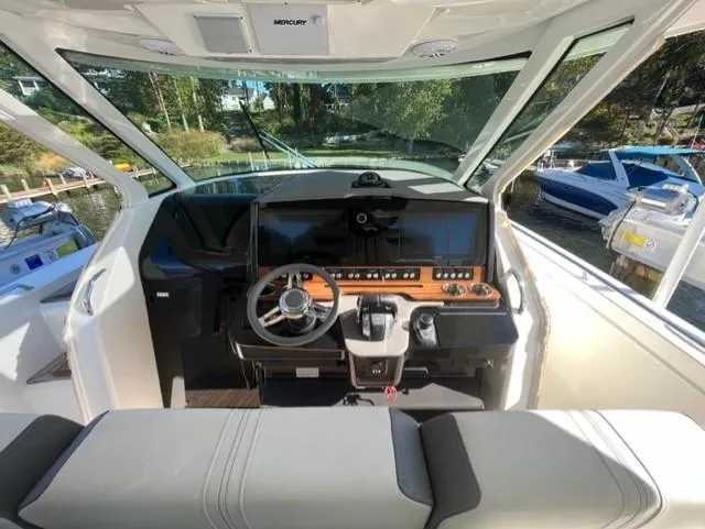 Slide: The Image of 2021 Tiara Yachts 38 LS helm station with modern controls and panoramic view. - 7