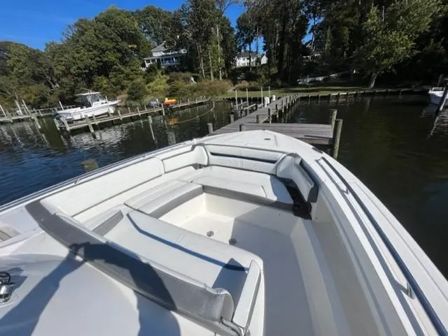 Slide: The Image of 2021 Tiara Yachts 38 LS boat docked at a serene marina. - 9