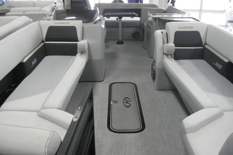 Slide: The Image of 2023 Harris FloteBote 250 Solstice pontoon boat with canopy, parked on a trailer. - 10