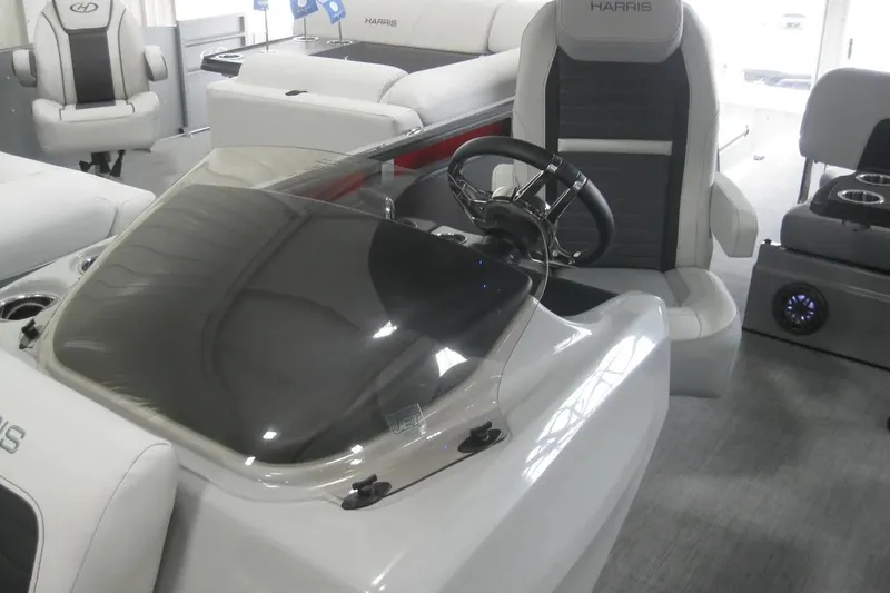Slide: The Image of 2023 Harris FloteBote 250 Solstice interior with table and seating area. - 16