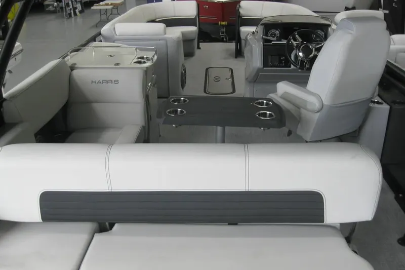 Slide: The Image of 2023 Harris FloteBote 250 Solstice interior with seating and table, featuring cup holders. - 22