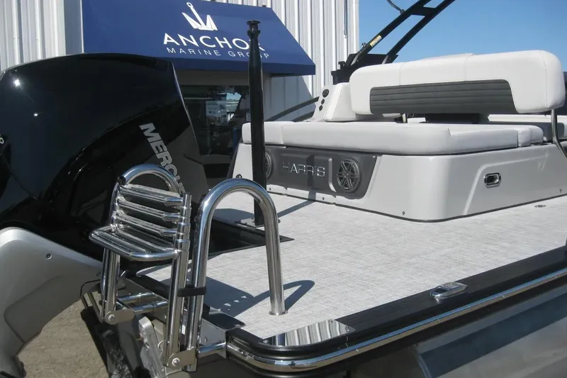 Slide: The Image of Close-up of 2023 Harris FloteBote 250 Solstice logo on a black surface. - 5