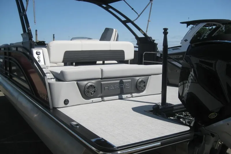 Slide: The Image of 2023 Harris FloteBote 250 Solstice pontoon boat with sleek design and powerful engine. - 7